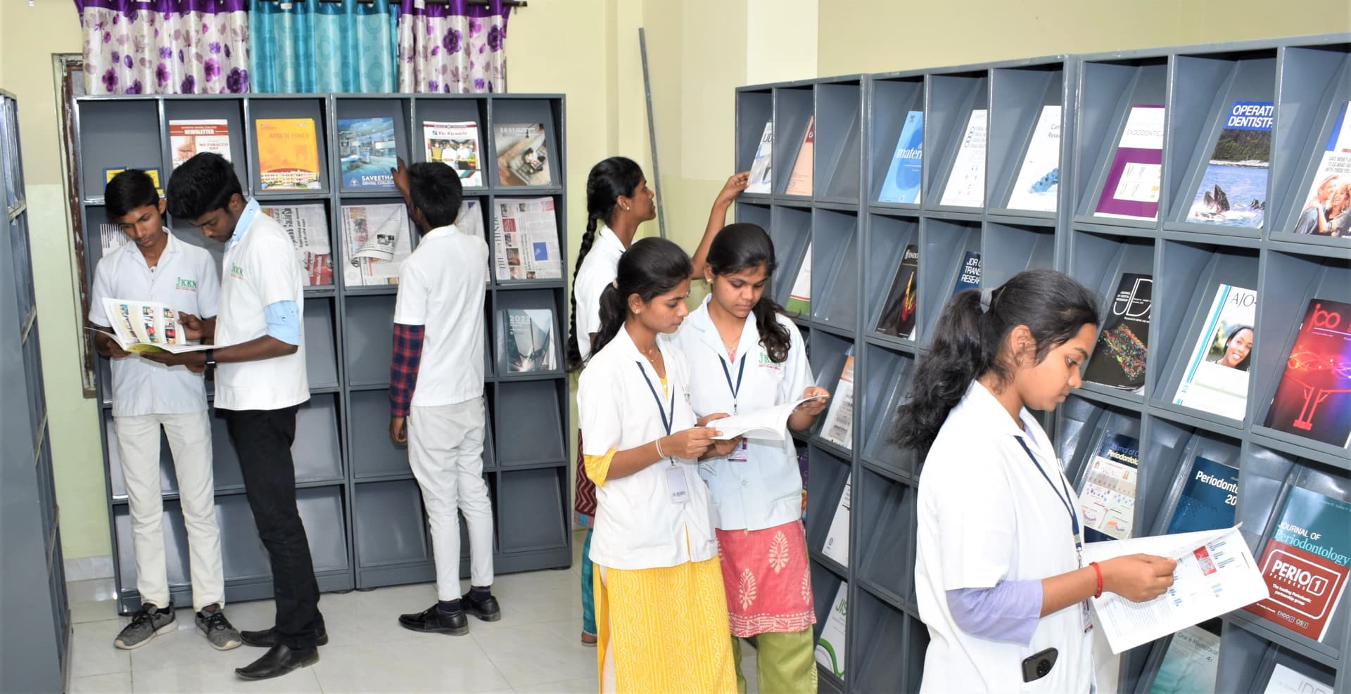 Students exploring journals and periodicals section at JKKN Dental College library